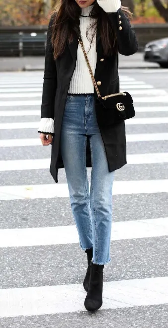 Still have that bell-sleeved top from the spring? Give it a preppy fall update by layering it underneath a military coat. Blue jeans and black booties accentuate the look perfectly.