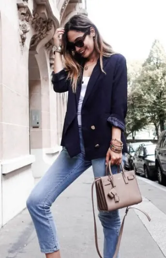 Get in on the trend by wearing a double-breasted navy blue blazer over cropped blue jeans and a simple white vest.