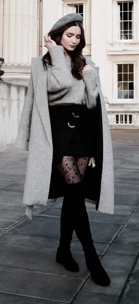 Timeless stylistic charm: wear a black miniskirt, patterned stockings and thigh-high boots with pale gray woolen extras.