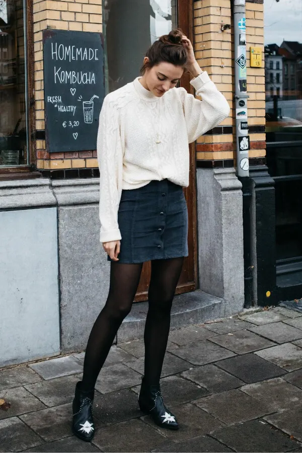 White cable knit sweater is something that you definitely need to own. It is pretty versatile. The blue mini skirt is the perfect item for winter layering. #skirtsinwinter #skirtoutif #winteroutfits