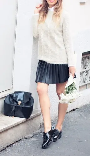 Style up a pair of shiny patent leather brogues with a cute pleated mini skirt and a cream-colored woolen sweater.