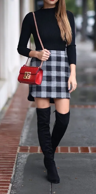 Get the sleek look by going for black on top and bottom with a splash of plaid print in the skirt.
