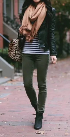 A silky oversized scarf makes a glamorous addition to this outfit of khaki pants, a striped top and leather jacket.