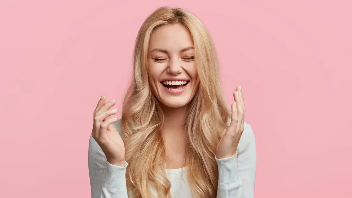 Blonde young woman laughs