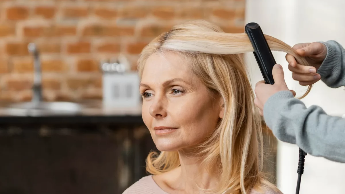 Woman getting her hair straightened