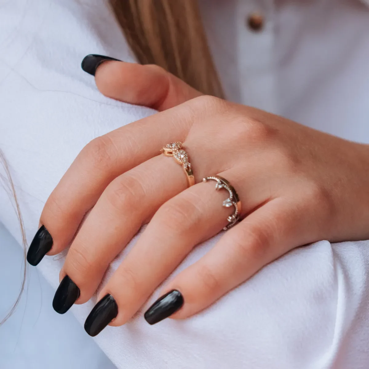 A hand with black nail polish