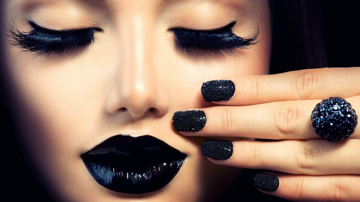 Beauty Fashion Girl with Trendy Caviar Black Manicure and Makeup