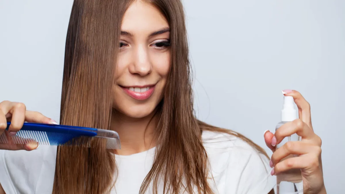 Woman hairbrushing hair with a brush