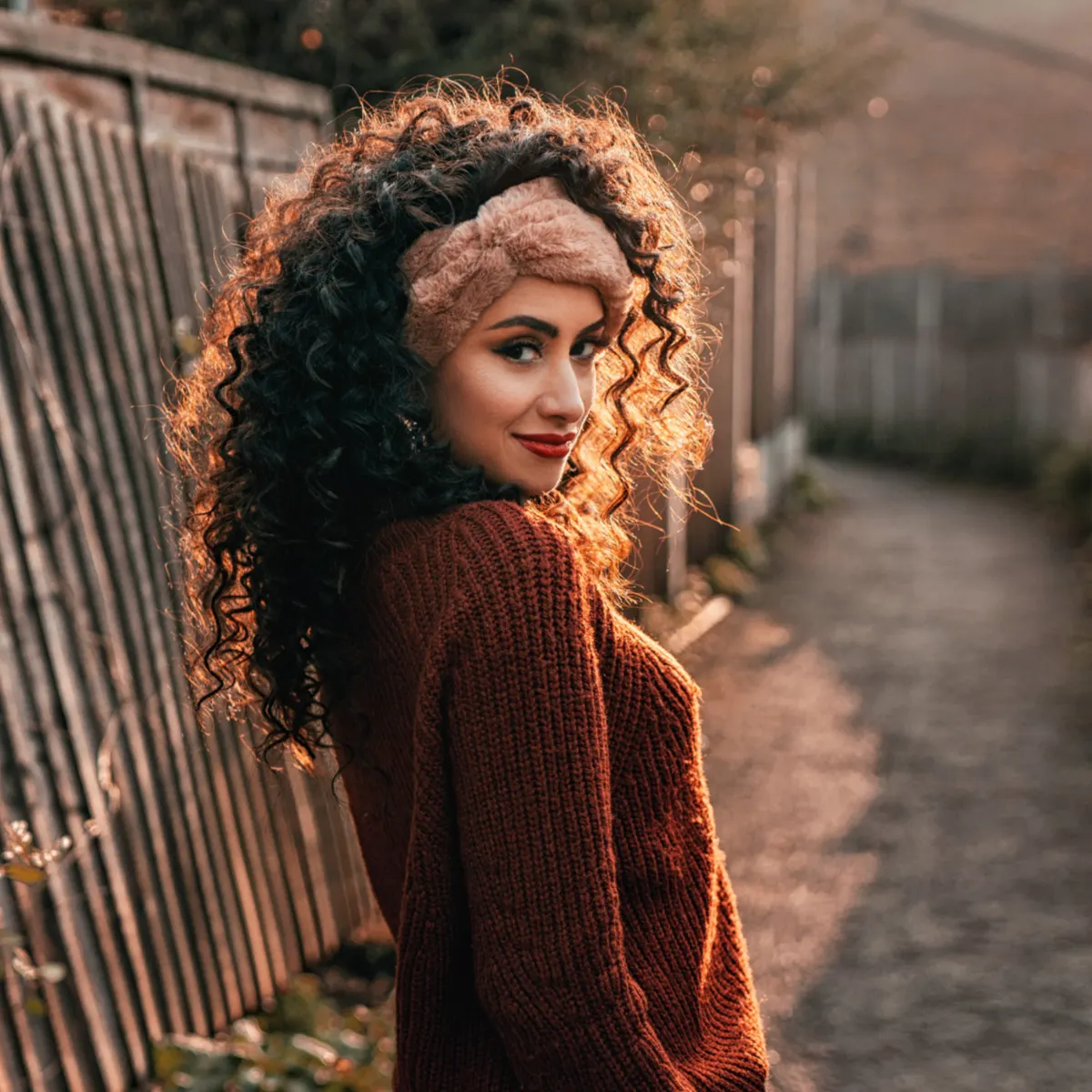 Woman with attractive curly hair. Find out how to enhance curly hair.
