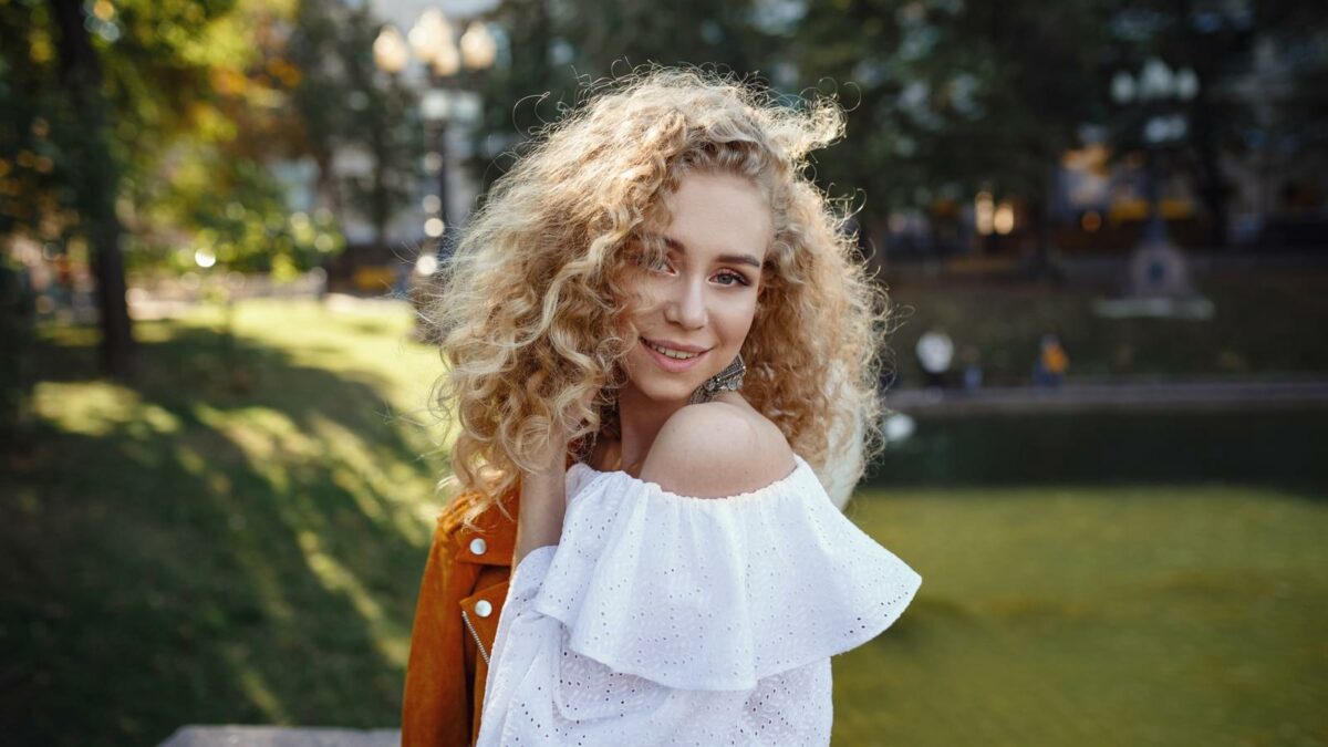 A beautiful young woman with blond curly hair