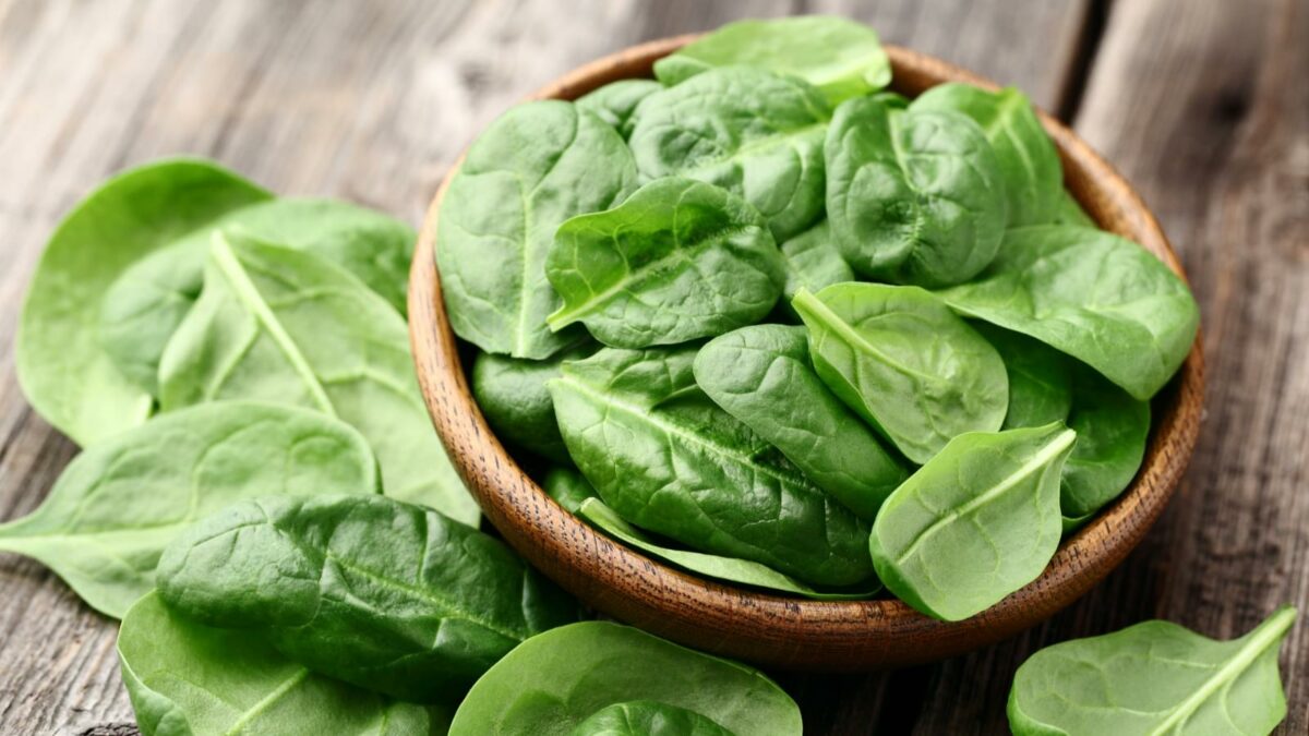 Spinach on a wooden background