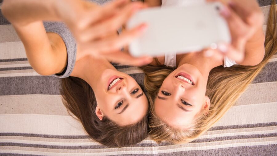 Woman friends with long hair taking selfie photo