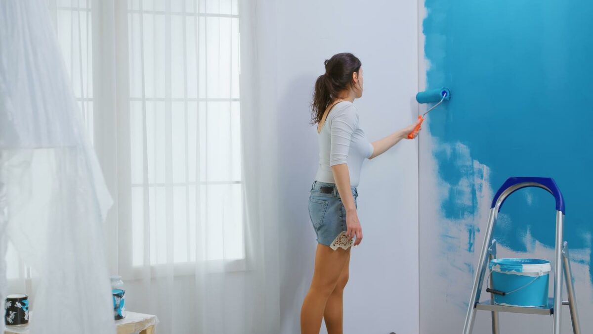 Woman painting wall