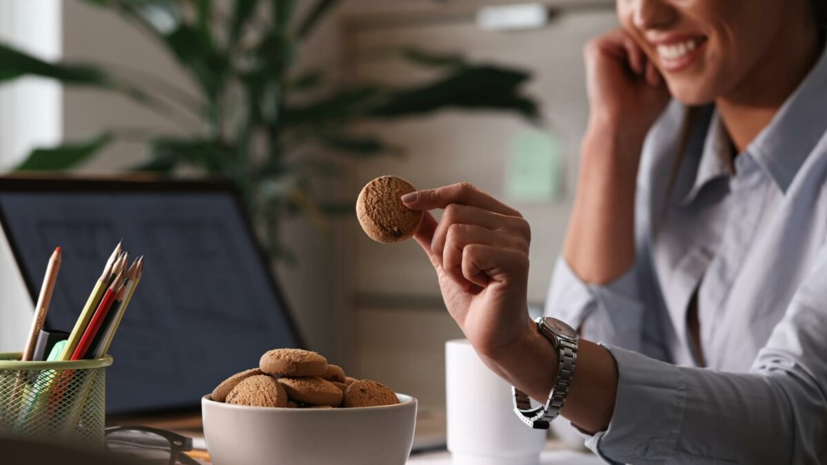 Female entrepreneur having a cookies for a snack in the office