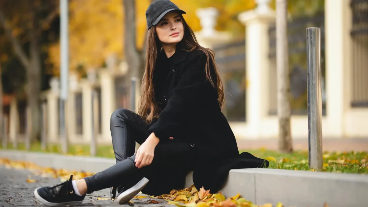 Portrait of attractive girl in autumn shades in black outfit