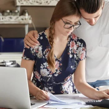 Couple managing budget together in the kitchen