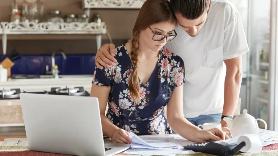 Couple managing budget together in the kitchen