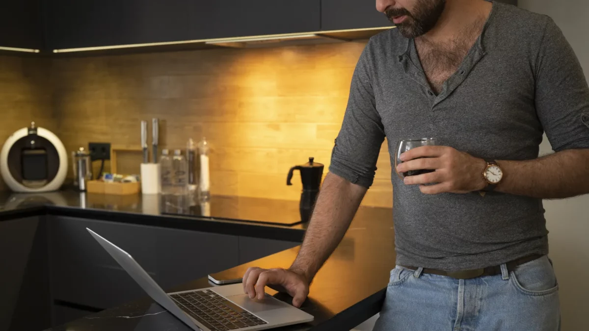 Man working with laptop and drinking coffee