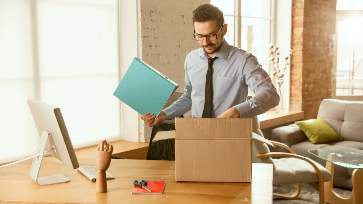 Young businessman moving out of office
