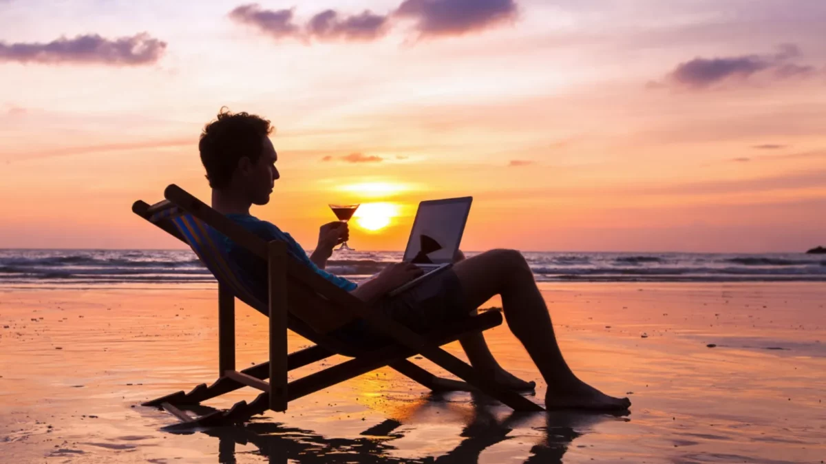Working with laptop on the beach, work abroad