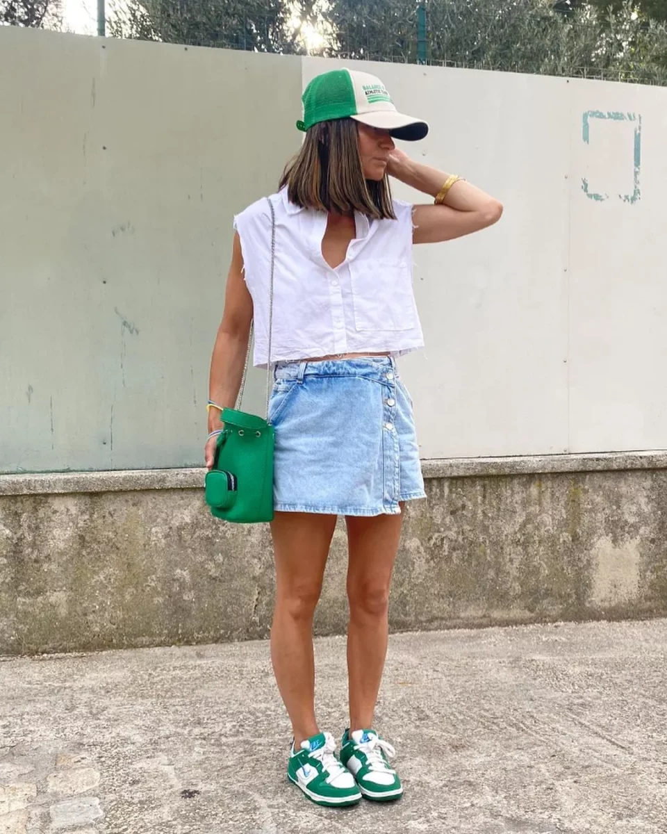 Wearing a white tee and denim skirt