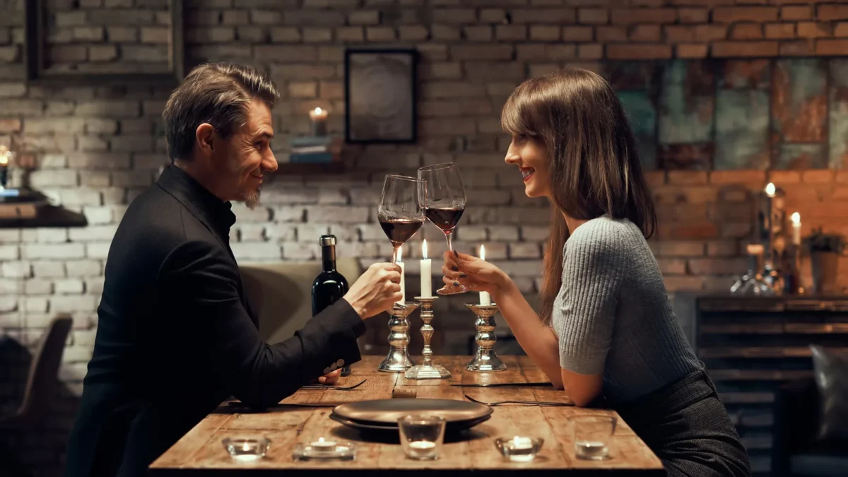 Couple drinking wine and having romantic dinner at home