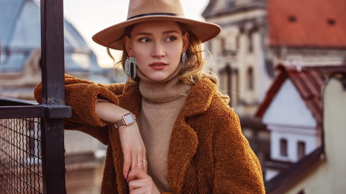 Elegant woman wearing beige hat wrist watch