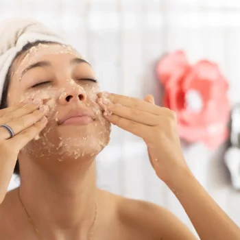 Girl at home applying an oatmeal face mask