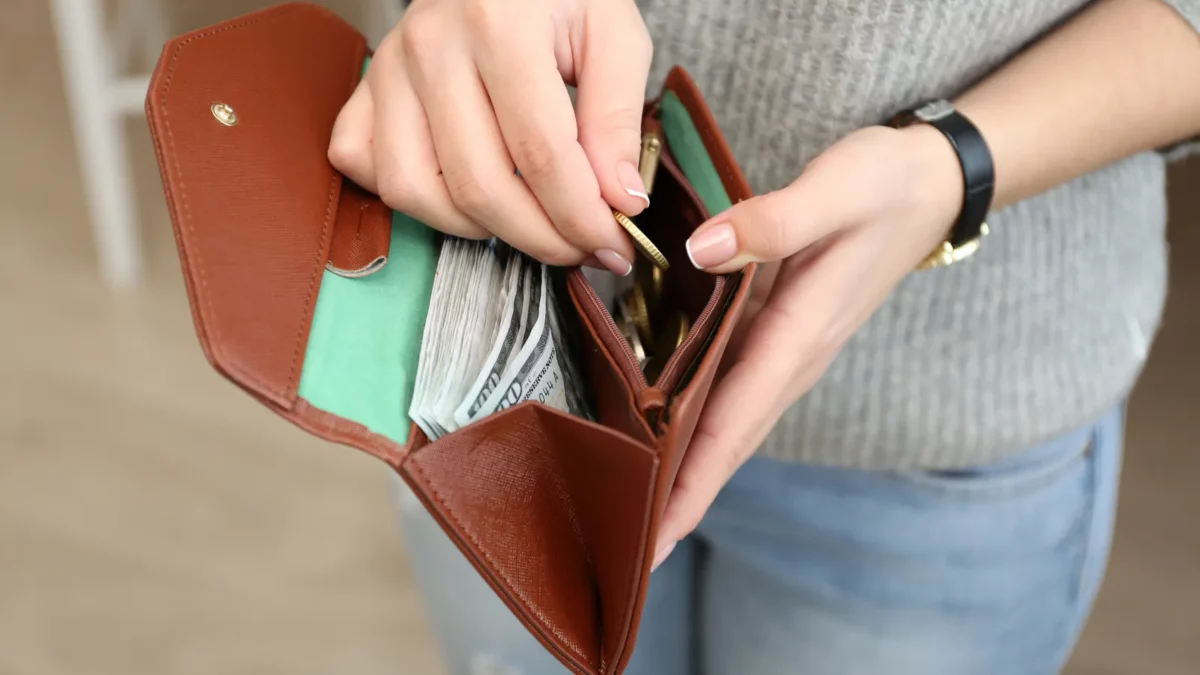 Girl with brown wallet with money