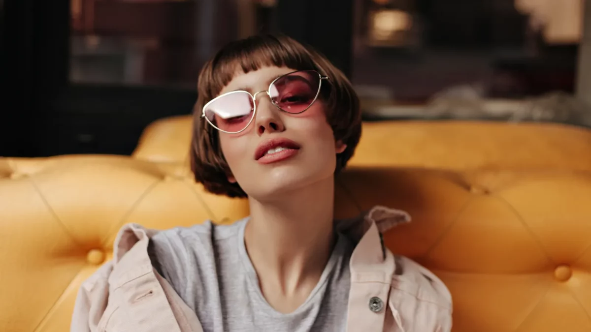 Girl with short hair in pink sunglasses