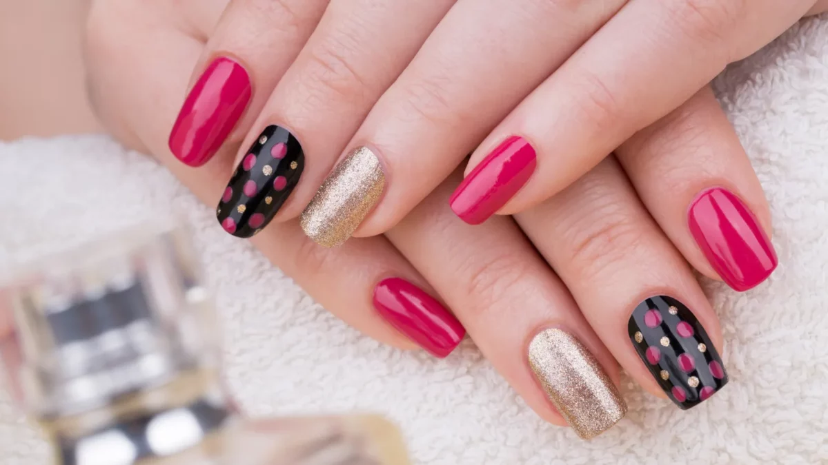 Round nails with nice pink, gold and black nail polish