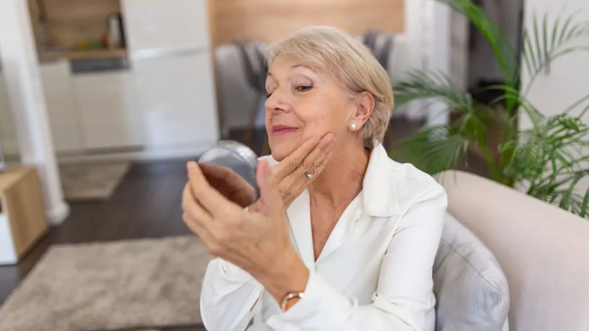 Senior woman applying anti wrinkles face cream