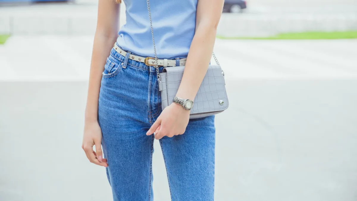 Stylish girl in light blue t shirt and denim classical jeans