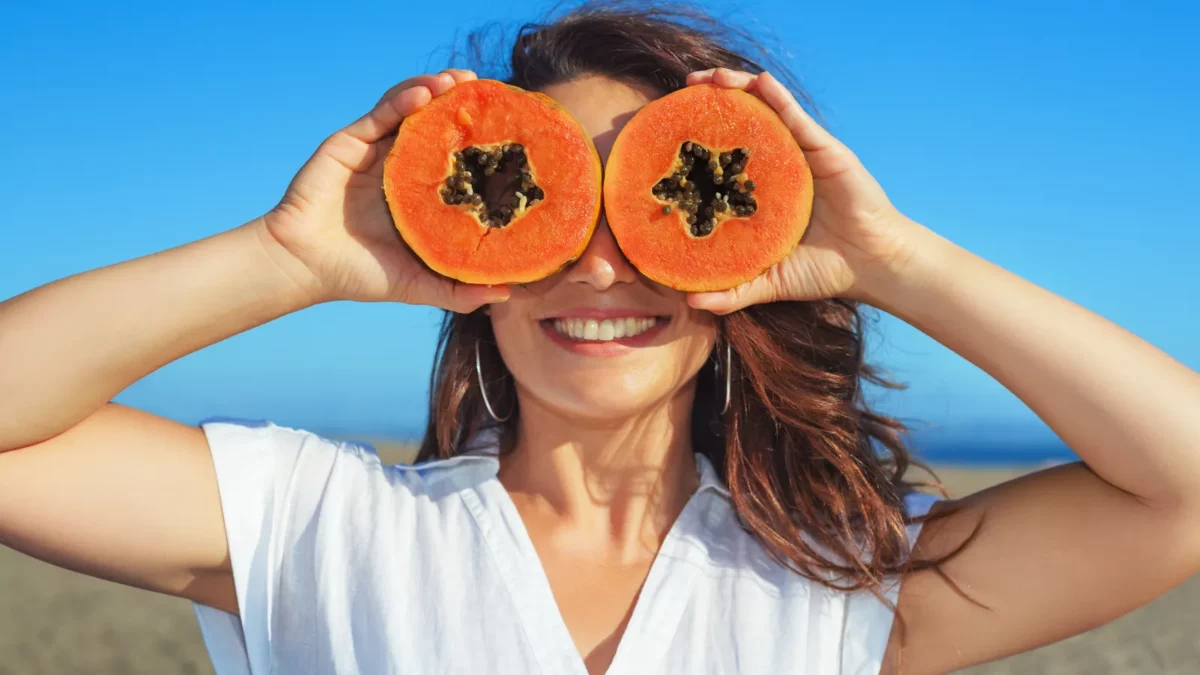 Woman holding in papaya