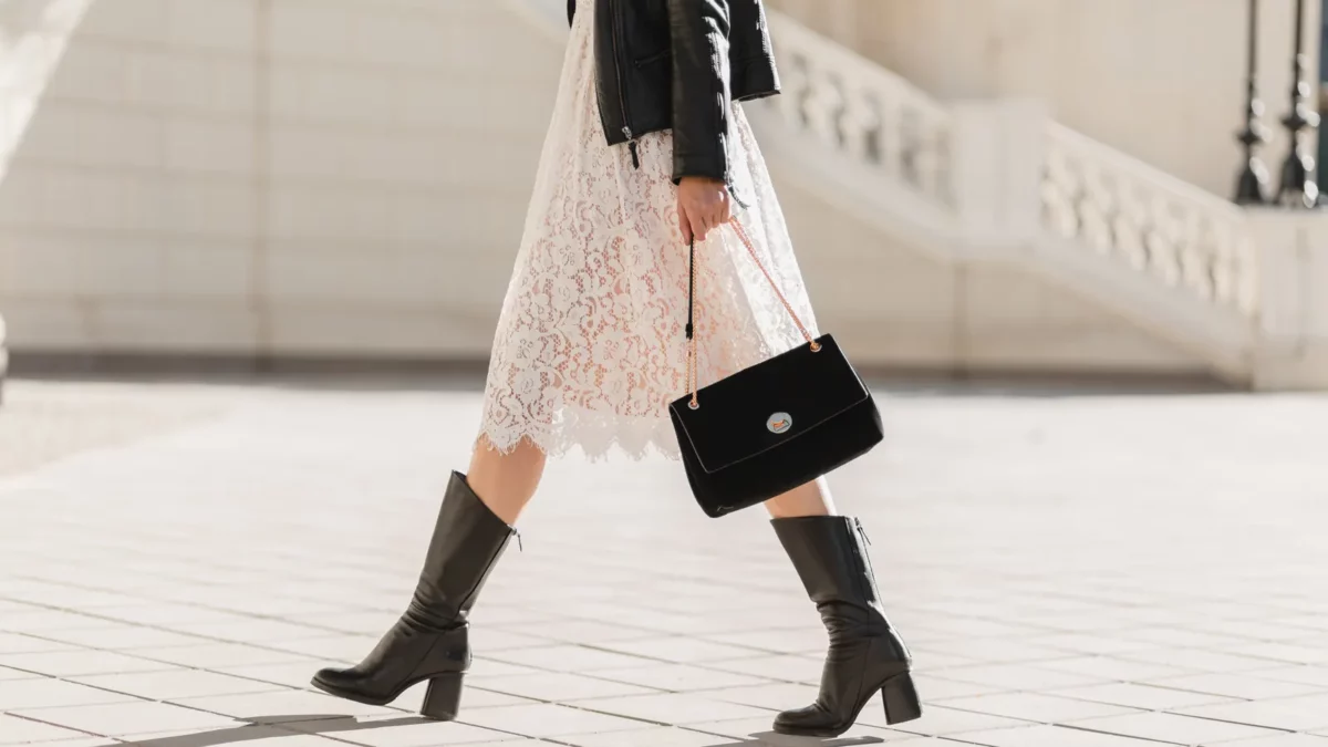 Woman in high leather boots holding purse