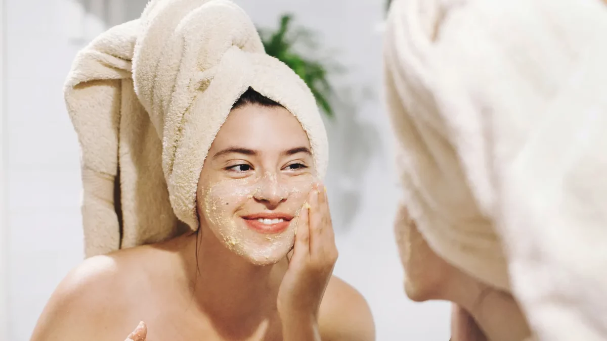 Woman making face massage with organic face scrub