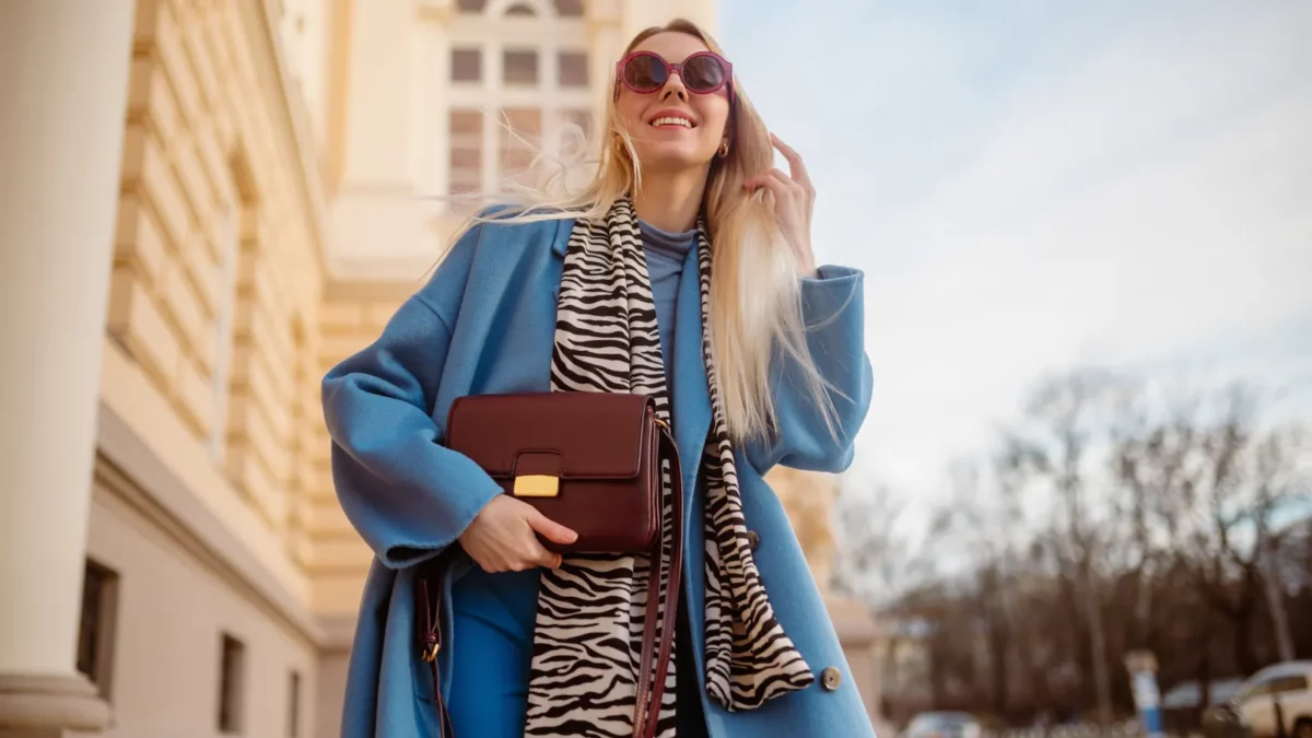 Woman with blue coat burgundy bag