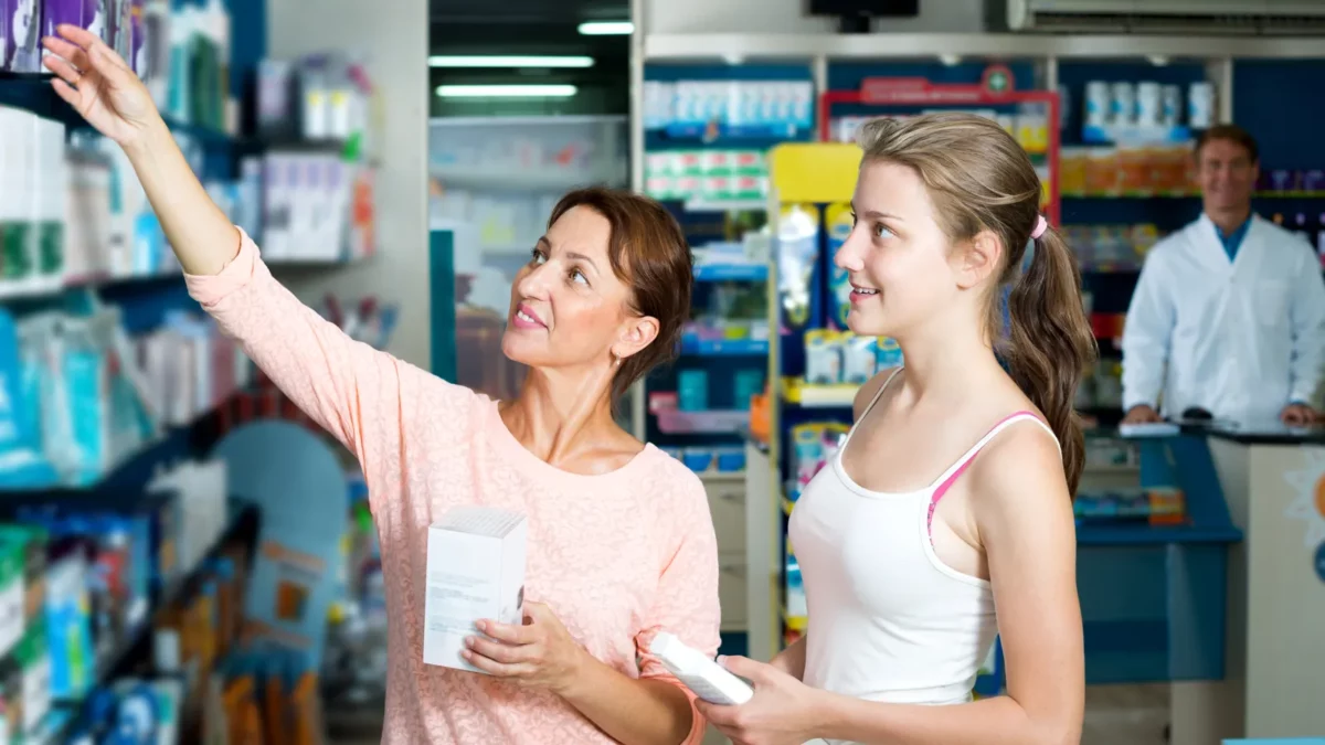 Woman with daughter shopping in drug store