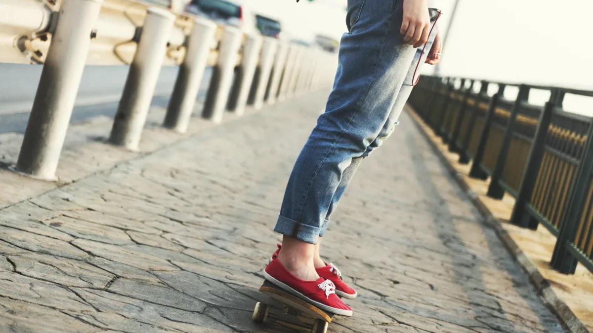 Woman with straight leg jeans on skateboard