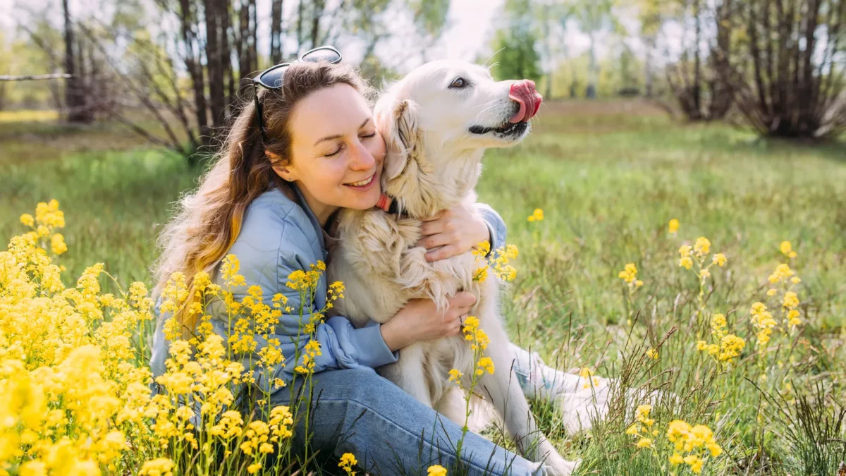 Young beautiful woman and her golden retriever dog