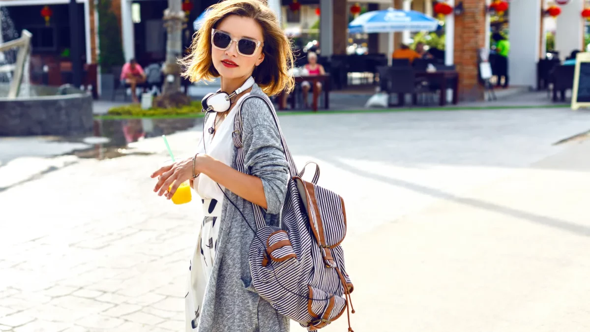 Young stylish hipster woman walking on the street