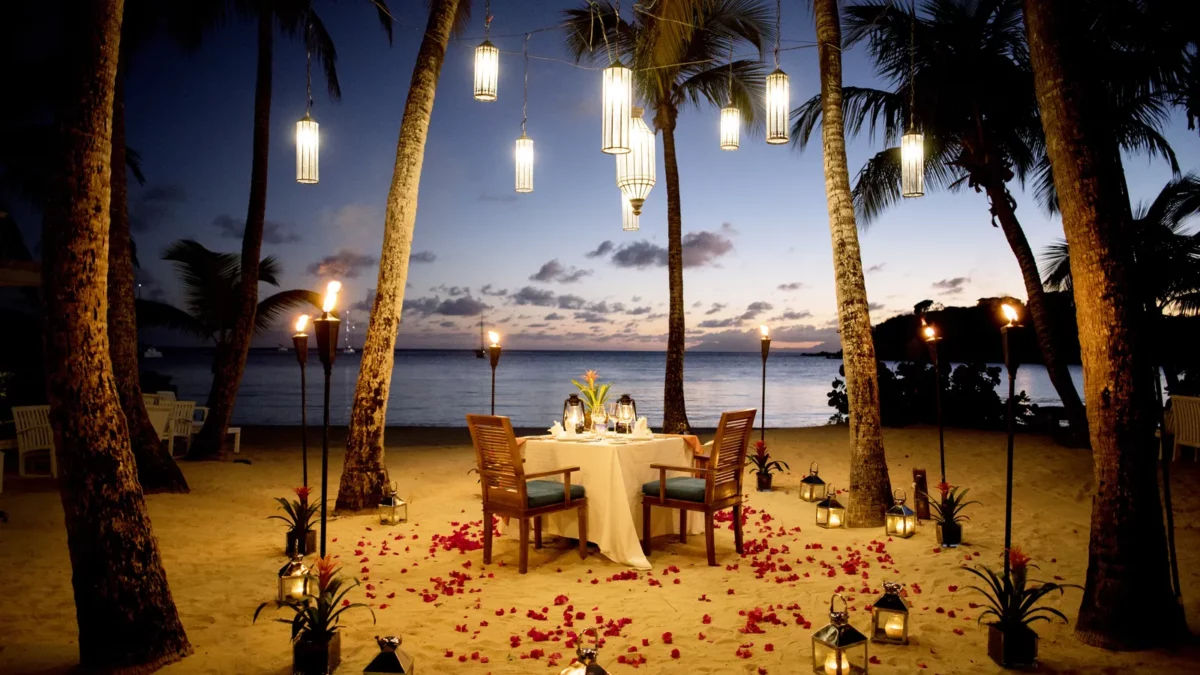 A table set up for a romantic meal on the beach