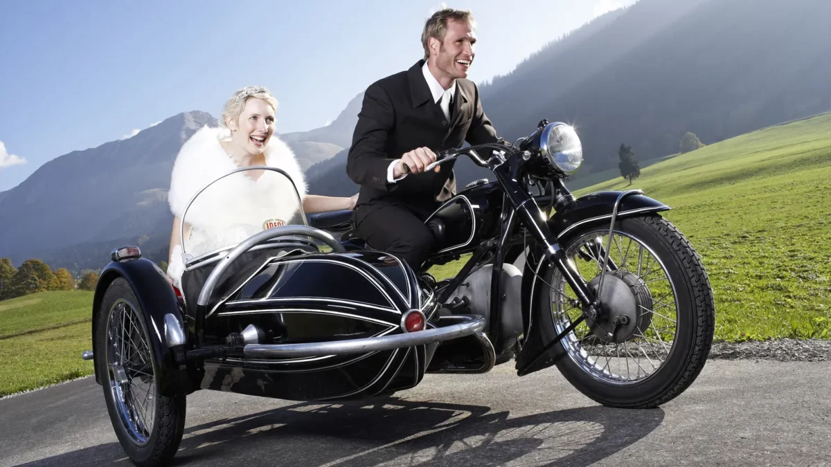 Bride and groom riding motorcycle