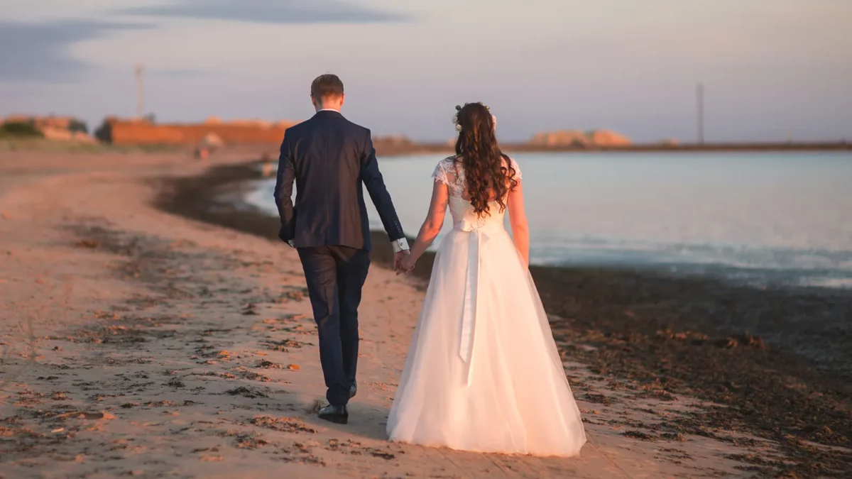 Couple on beach on wedding day