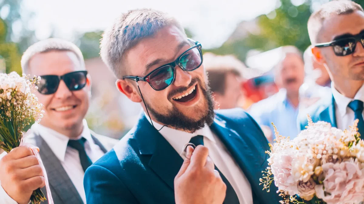 Smiling wedding guests in sunglasses