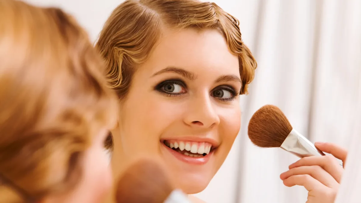 Smiling woman doing makeup
